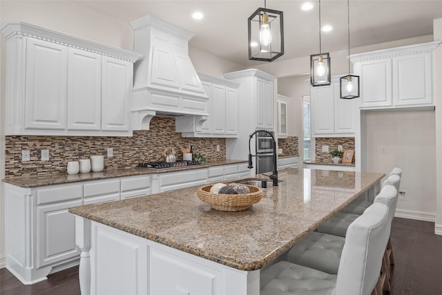 2820 Annandale Dr, Trophy Club, TX 76262 - kitchen featuring stainless steel gas stovetop, dark wood finished floors, white cabinetry, baseboards, and custom range hood