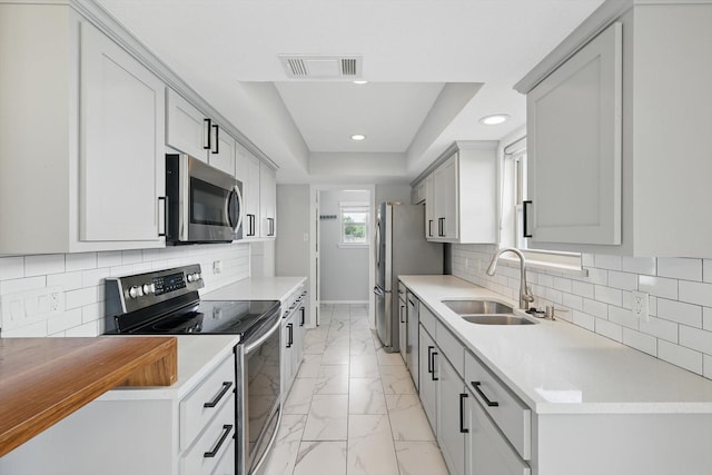 4448 Atlanta Dr, Plano, TX 75093 - kitchen featuring stainless steel appliances, a sink, light marble finish floors, recessed lighting, and baseboards