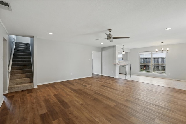 4448 Atlanta Dr, Plano, TX 75093 - unfurnished living room featuring ceiling fan, a chandelier, stairs, wood finished floors, and baseboards