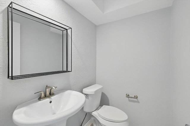 4448 Atlanta Dr, Plano, TX 75093 - half bath with a sink, toilet, and a textured wall