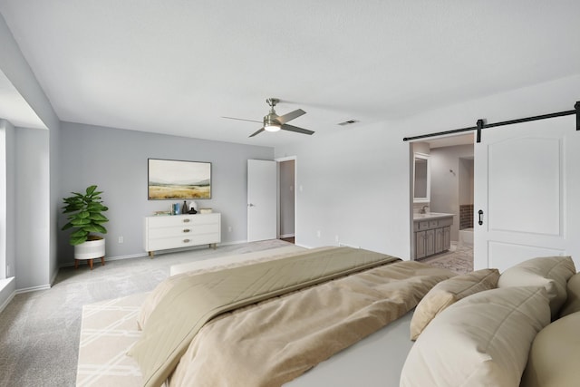 4448 Atlanta Dr, Plano, TX 75093 - bedroom featuring a barn door, baseboards, light colored carpet, connected bathroom, and ceiling fan