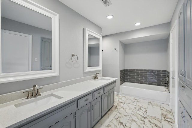 4448 Atlanta Dr, Plano, TX 75093 - bathroom with marble look tiles, double vanity, a garden tub, and recessed lighting