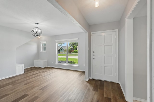 4448 Atlanta Dr, Plano, TX 75093 - foyer entrance featuring wood finished floors, baseboards, and a chandelier