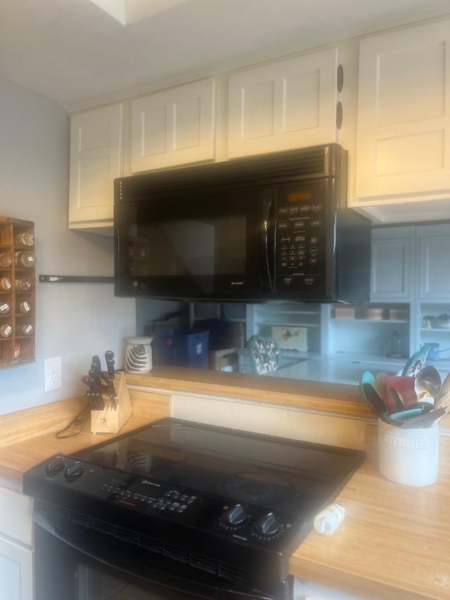 2665 Via, Los Altos, Carrollton, TX 75006 - kitchen featuring black appliances and white cabinetry