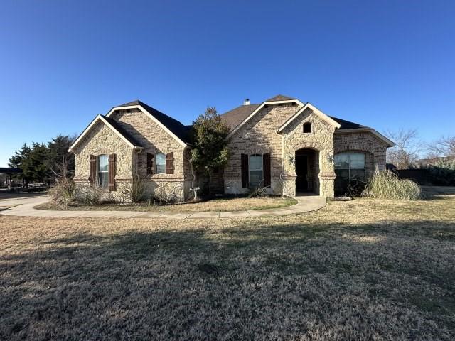 5851 Sweetwater Dr, Midlothian, TX 76065 - french country home featuring a front lawn, stone siding, and brick siding