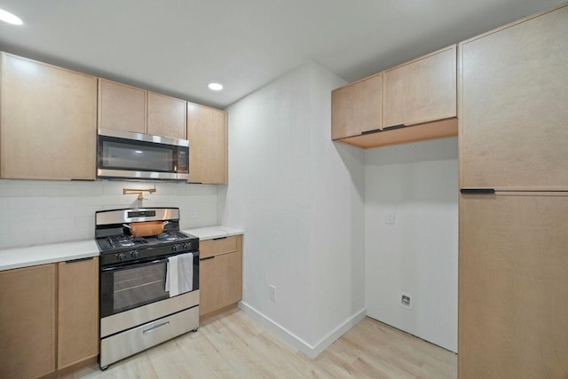 4709 Albermarle Dr, Fort Worth, TX 76132 - kitchen with appliances with stainless steel finishes, light wood finished floors, light brown cabinets, light countertops, and recessed lighting