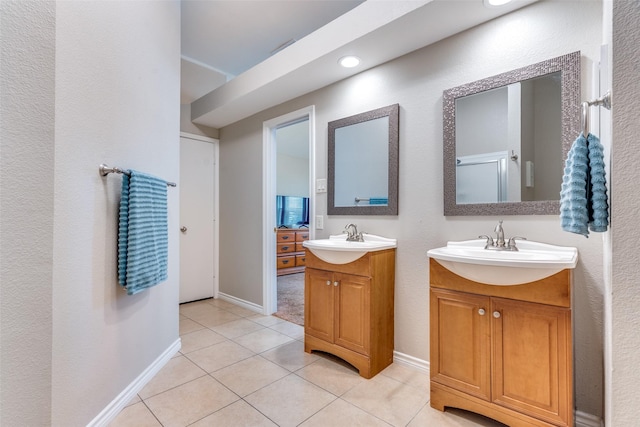 807 Autumn Hill Dr, Wylie, TX 75098 - full bath with two vanities, tile patterned flooring, and baseboards
