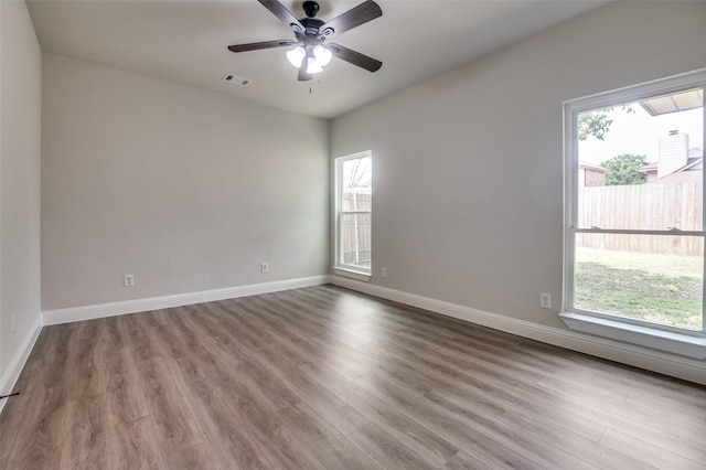 829 Foxridge Dr, Arlington, TX 76017 - spare room featuring wood finished floors, a ceiling fan, and baseboards