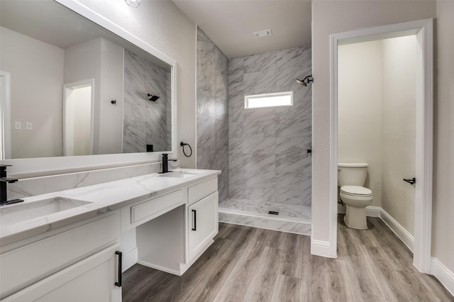 829 Foxridge Dr, Arlington, TX 76017 - full bathroom with a marble finish shower, toilet, double vanity, and wood finished floors