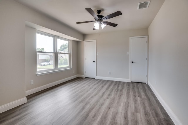 829 Foxridge Dr, Arlington, TX 76017 - unfurnished bedroom featuring wood finished floors, baseboards, and ceiling fan
