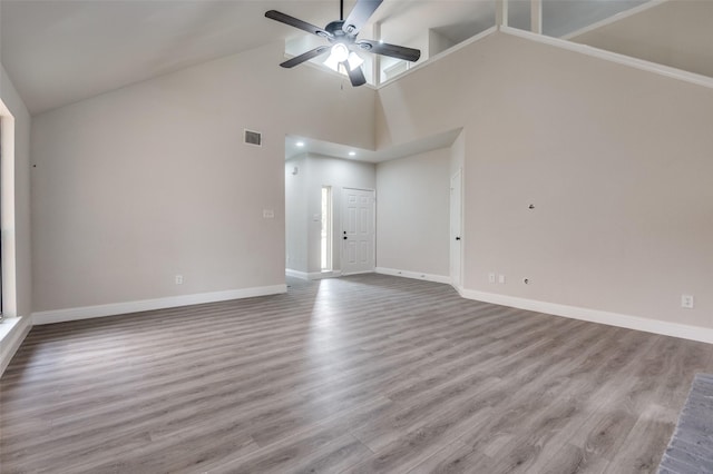 829 Foxridge Dr, Arlington, TX 76017 - unfurnished living room featuring a ceiling fan, baseboards, wood finished floors, and high vaulted ceiling