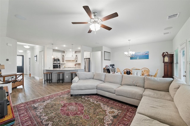 2109 Liriope Ln, Waxahachie, TX 75165 - living room featuring light wood finished floors, a chandelier, ceiling fan, recessed lighting, and baseboards