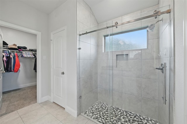2109 Liriope Ln, Waxahachie, TX 75165 - bathroom featuring a stall shower, tile patterned floors, a spacious closet, and baseboards