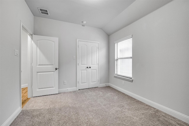 2109 Liriope Ln, Waxahachie, TX 75165 - unfurnished bedroom with carpet, baseboards, lofted ceiling, and a closet