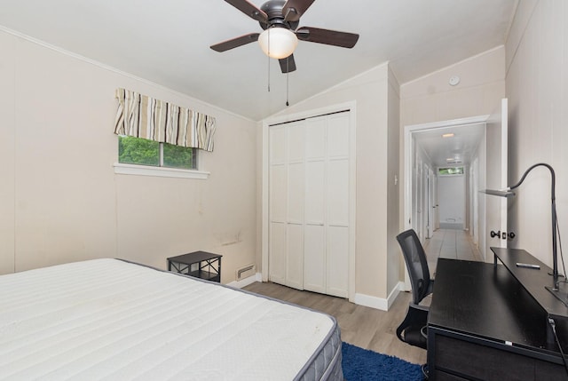 1705 Jefferson St, Commerce, TX 75428 - bedroom with vaulted ceiling, wood finished floors, a closet, ceiling fan, and baseboards