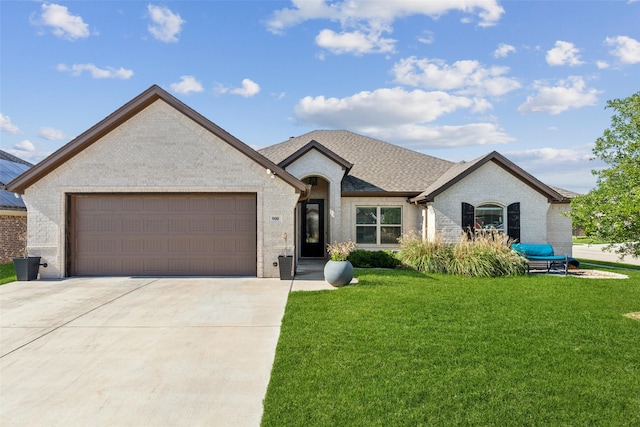 900 E 5th St, Springtown, TX 76082 - french country inspired facade with brick siding, a garage, a front lawn, and driveway