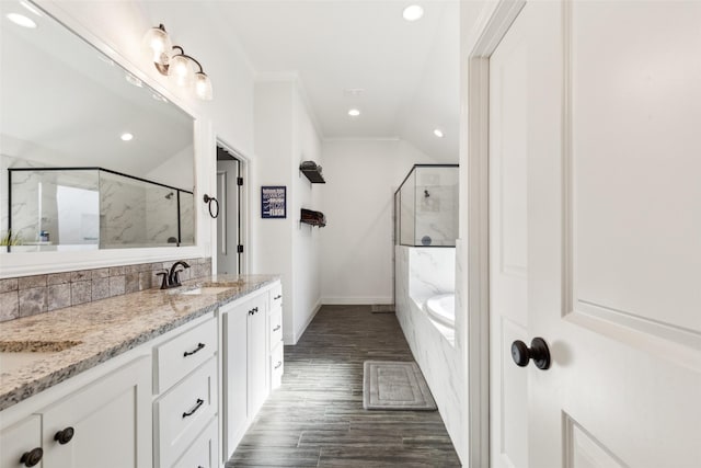 900 E 5th St, Springtown, TX 76082 - full bath featuring a marble finish shower, a garden tub, double vanity, wood finished floors, and baseboards