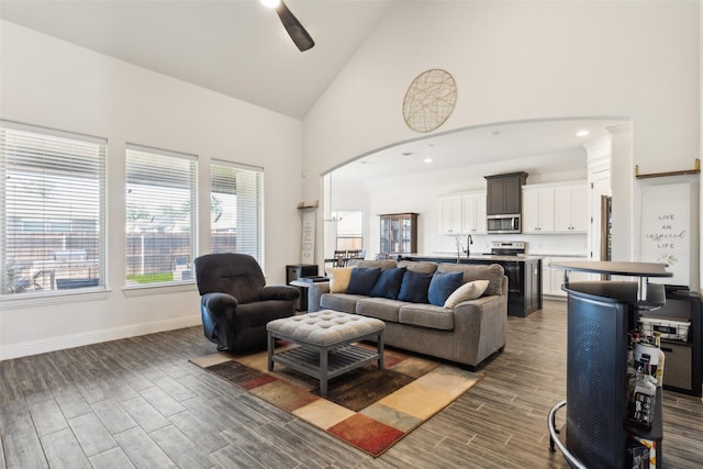 900 E 5th St, Springtown, TX 76082 - living area with dark wood-style flooring, high vaulted ceiling, baseboards, and a ceiling fan