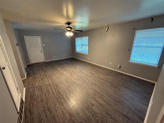 704 Faun Dr, Euless, TX 76040 - spare room featuring dark wood-style floors, ceiling fan, and baseboards