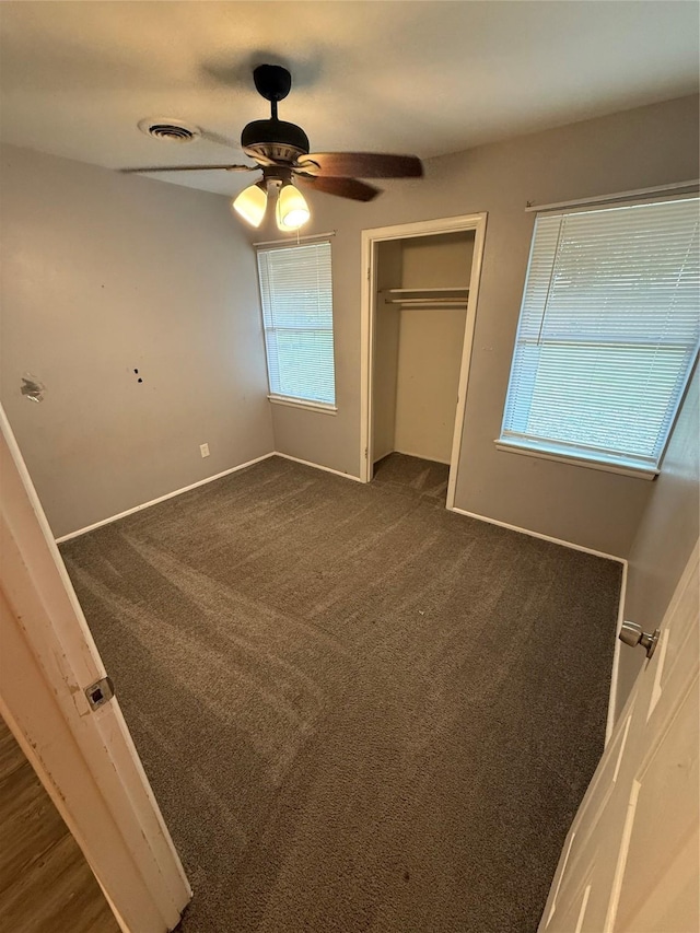 704 Faun Dr, Euless, TX 76040 - unfurnished bedroom featuring a closet, dark colored carpet, ceiling fan, and baseboards