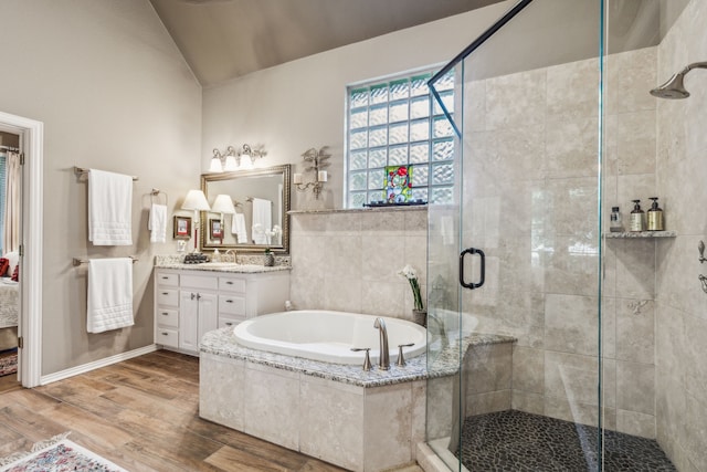600 Loving Ct, Southlake, TX 76092 - full bath featuring lofted ceiling, vanity, a stall shower, a bath, and wood finished floors