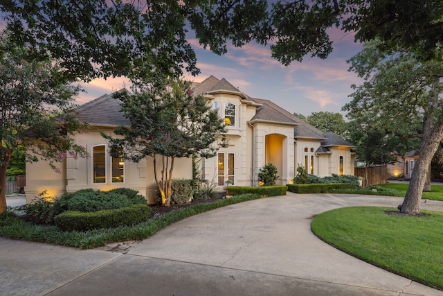 600 Loving Ct, Southlake, TX 76092 - french country home with stucco siding, curved driveway, and a shingled roof