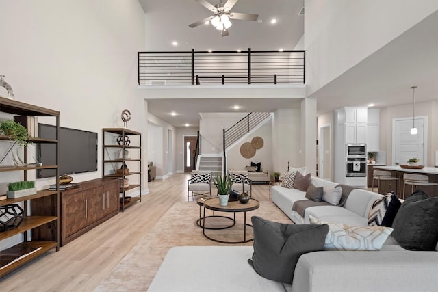 2605 Rosewood Way, Northlake, TX 76226 - living area featuring a towering ceiling, light wood-style floors, ceiling fan, stairway, and recessed lighting