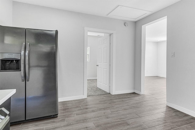 2735 Grafton Ave, Dallas, TX 75211 - kitchen featuring stainless steel fridge with ice dispenser, wood finished floors, and light countertops