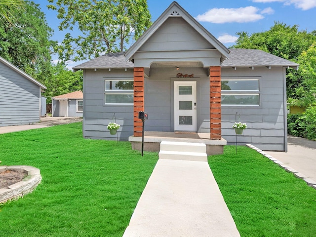 2735 Grafton Ave, Dallas, TX 75211 - view of front facade featuring a shingled roof and a front lawn