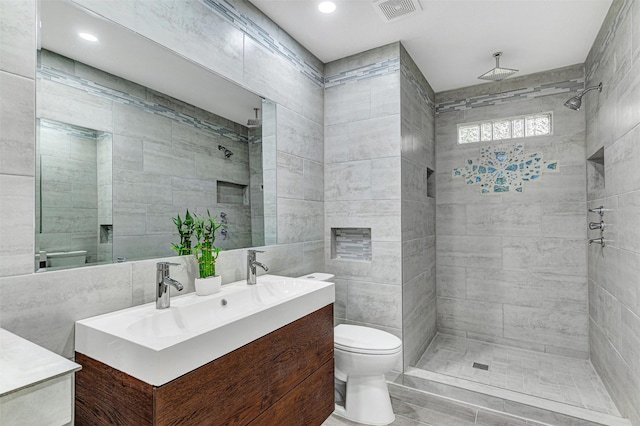 2735 Grafton Ave, Dallas, TX 75211 - full bath featuring vanity, tiled shower, tile walls, and recessed lighting