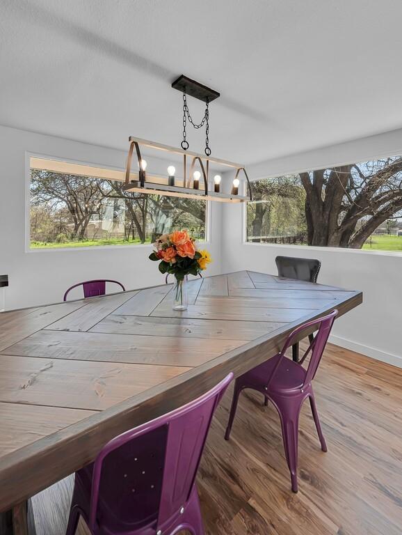 1835 Fort Graham Rd, Waco, TX 76705 - dining space with plenty of natural light, a chandelier, and wood finished floors