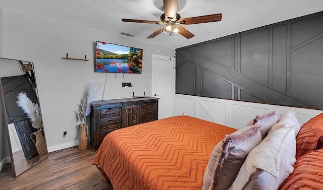 1835 Fort Graham Rd, Waco, TX 76705 - bedroom with a decorative wall, baseboards, wood finished floors, and ceiling fan