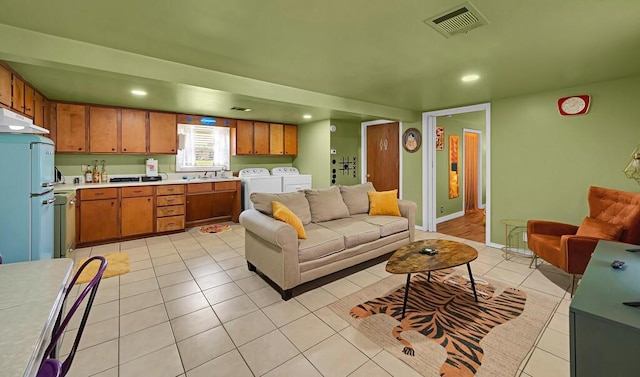 1835 Fort Graham Rd, Waco, TX 76705 - living area featuring independent washer and dryer, light tile patterned floors, and recessed lighting