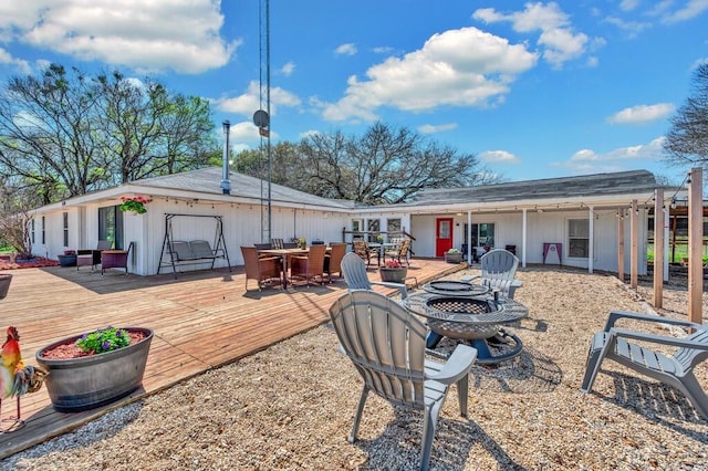 1835 Fort Graham Rd, Waco, TX 76705 - rear view of house featuring an outdoor fire pit, outdoor dining space, and a deck