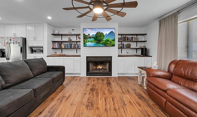 1835 Fort Graham Rd, Waco, TX 76705 - living room with a ceiling fan, light wood-type flooring, a fireplace, and recessed lighting