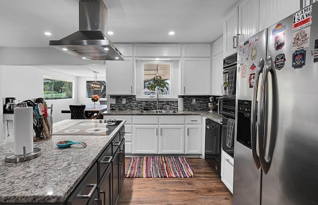 1835 Fort Graham Rd, Waco, TX 76705 - kitchen featuring black appliances, wall chimney range hood, a sink, white cabinets, and recessed lighting