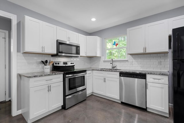 2915 Ethel Ave, Waco, TX 76707 - kitchen with appliances with stainless steel finishes, a sink, finished concrete floors, light stone counters, and white cabinetry