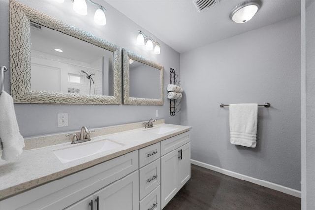 2915 Ethel Ave, Waco, TX 76707 - full bathroom with double vanity, a shower, and baseboards