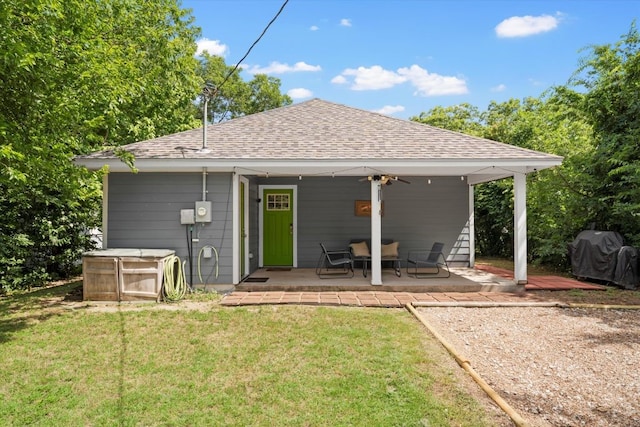 2915 Ethel Ave, Waco, TX 76707 - rear view of house with a patio area, a yard, and a shingled roof