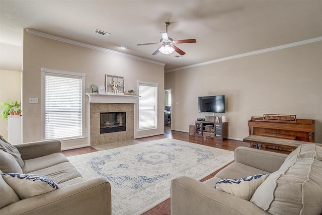 320 Westgate Dr, Aledo, TX 76008 - living area featuring ceiling fan, ornamental molding, wood finished floors, a tiled fireplace, and baseboards
