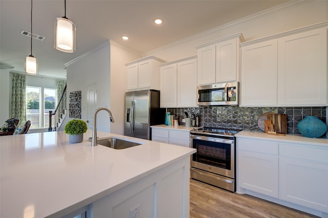 603 E Midway, Euless, TX 76039 - kitchen with appliances with stainless steel finishes, a sink, crown molding, tasteful backsplash, and light countertops