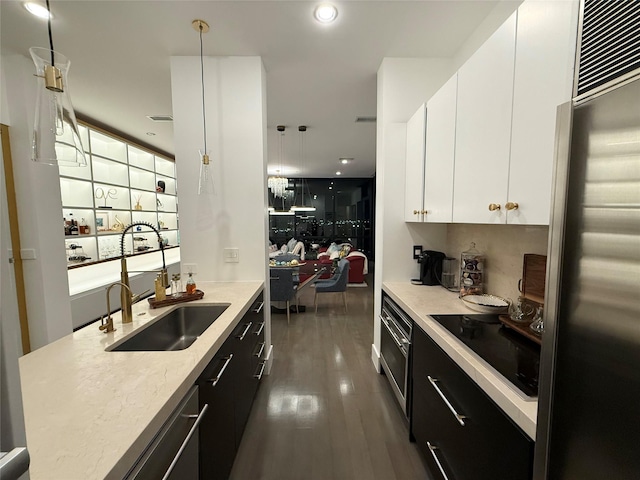 2200 Victory Ave Unit 2306, Dallas, TX 75219 - kitchen with a sink, stainless steel appliances, dark cabinets, white cabinets, and recessed lighting