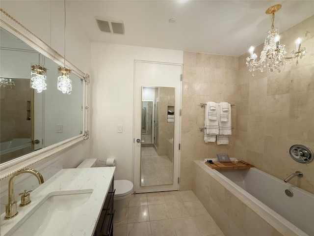 2200 Victory Ave Unit 2306, Dallas, TX 75219 - bathroom with a bathtub, vanity, toilet, marble look tile flooring, and a chandelier
