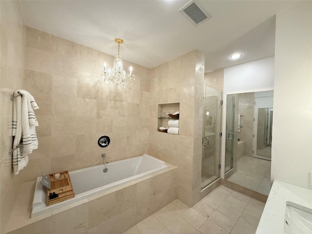 2200 Victory Ave Unit 2306, Dallas, TX 75219 - full bath with a garden tub, tile patterned floors, tile walls, a chandelier, and a shower stall
