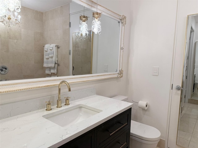 2200 Victory Ave Unit 2306, Dallas, TX 75219 - bathroom featuring toilet, vanity, and a chandelier
