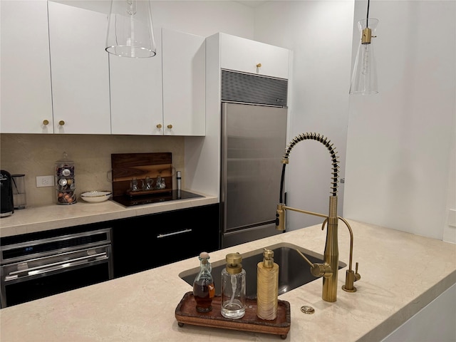 2200 Victory Ave Unit 2306, Dallas, TX 75219 - kitchen featuring stainless steel built in fridge, oven, light countertops, and decorative light fixtures