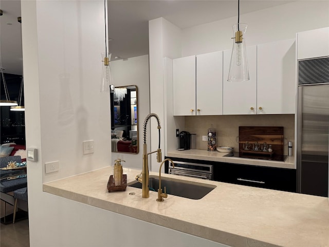 2200 Victory Ave Unit 2306, Dallas, TX 75219 - kitchen with light countertops, a sink, white cabinets, and high end refrigerator