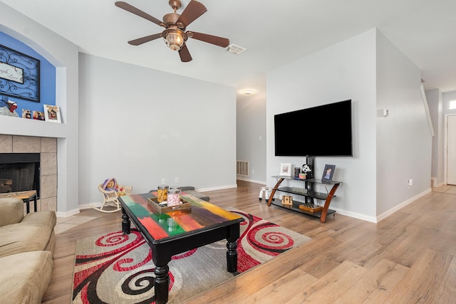 2344 Magnolia Dr, Little Elm, TX 75068 - living area featuring a ceiling fan, wood finished floors, baseboards, and a tile fireplace