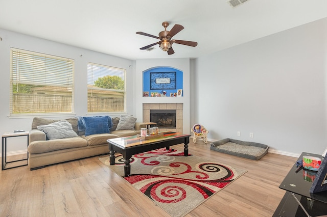 2344 Magnolia Dr, Little Elm, TX 75068 - living room with wood finished floors, a ceiling fan, baseboards, and a tile fireplace