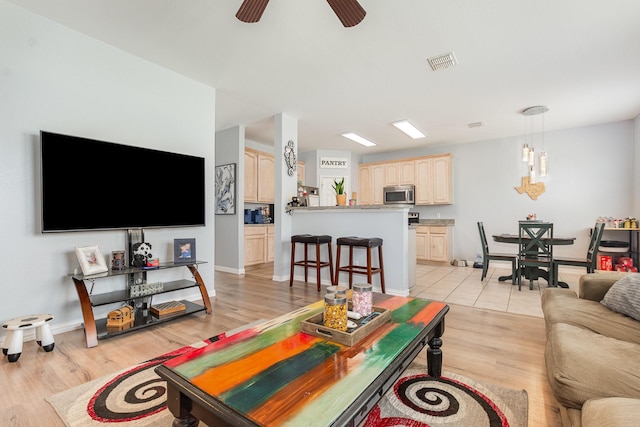 2344 Magnolia Dr, Little Elm, TX 75068 - living room featuring light wood-type flooring, baseboards, and ceiling fan